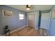 This bedroom features light blue walls, modern wood floors, and a closet with decorative barn doors at 705 S 450 E, Franklin, IN 46131