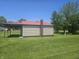 Side view of the exterior with mature tree and nice grassy area at 705 S 450 E, Franklin, IN 46131
