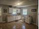 Bright kitchen with white cabinets, light countertops, tile floors, and a large window at 705 S 450 E, Franklin, IN 46131