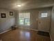 Bright living room with natural light, wood floors and a welcoming front door entrance at 705 S 450 E, Franklin, IN 46131