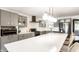 Modern kitchen featuring a large center island, stainless steel appliances, and gray cabinetry at 7110 N Layman Ave, Indianapolis, IN 46250