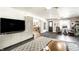 Open living space with a modern media center, dark tile floors, and contemporary furnishings at 7110 N Layman Ave, Indianapolis, IN 46250