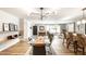 Spacious living and dining area boasts wood floors and contemporary furnishings at 7110 N Layman Ave, Indianapolis, IN 46250