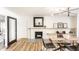 Inviting living room with a fireplace, wood floors, modern lighting, and neutral decor at 7110 N Layman Ave, Indianapolis, IN 46250