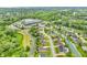 Stunning aerial view of a neighborhood with lush greenery, beautiful homes, and a community pool with a lazy river at 720 Willow Pointe North Dr, Plainfield, IN 46168