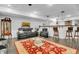 Bright basement living space features black leather seating, a vibrant rug, and bar with liquor storage at 720 Willow Pointe North Dr, Plainfield, IN 46168