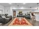 Finished basement boasts a large red rug, black leather seating, and a bar with pendant lighting at 720 Willow Pointe North Dr, Plainfield, IN 46168