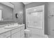 Bathroom featuring a white vanity with oval mirror and a tiled shower at 720 Willow Pointe North Dr, Plainfield, IN 46168