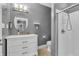 Bathroom featuring white vanity with oval mirror and a tiled shower with glass door at 720 Willow Pointe North Dr, Plainfield, IN 46168