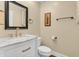 Elegant powder room featuring a white vanity with a marble countertop and stylish bronze fixtures at 720 Willow Pointe North Dr, Plainfield, IN 46168