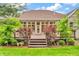 The wooden deck features access to the home and backyard with lush plantings at 720 Willow Pointe North Dr, Plainfield, IN 46168