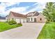 Beautiful brick home with a three-car garage and a concrete driveway at 720 Willow Pointe North Dr, Plainfield, IN 46168