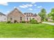Inviting brick home with a manicured lawn and beautiful landscaping at 720 Willow Pointe North Dr, Plainfield, IN 46168