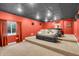 Home theater in basement featuring tiered seating, dark ceiling, and a projector setup at 720 Willow Pointe North Dr, Plainfield, IN 46168