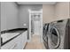 Functional laundry room with modern washer/dryer, storage cabinets, and a sink at 720 Willow Pointe North Dr, Plainfield, IN 46168