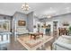 Expansive living room with hardwood floors, white sofas, and modern kitchen in the background at 720 Willow Pointe North Dr, Plainfield, IN 46168