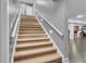 Carpeted stairway leading to a basement bar area with tiled floors at 720 Willow Pointe North Dr, Plainfield, IN 46168