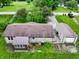Aerial view of a home with a well-maintained roof, sunroom, detached garage, and a neatly kept yard at 7214 W Reformatory Rd, Fortville, IN 46040