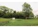 Expansive backyard with mature trees, a charming shed, and a classic wooden fence, perfect for outdoor enjoyment at 7214 W Reformatory Rd, Fortville, IN 46040