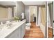 Well-maintained bathroom with a classic vanity, wood-look flooring, and shower-tub combo at 7214 W Reformatory Rd, Fortville, IN 46040