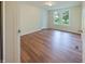 Vacant bedroom featuring wood-look flooring, double window, and neutral walls at 7214 W Reformatory Rd, Fortville, IN 46040