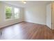 Bright, empty bedroom with wood-look flooring and a double window overlooking outdoors at 7214 W Reformatory Rd, Fortville, IN 46040
