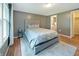 Serene bedroom featuring hardwood floors, a comfortable bed, and natural light from the window at 7214 W Reformatory Rd, Fortville, IN 46040