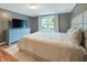 Comfortable bedroom with stylish blue dresser, plush carpet, and natural light at 7214 W Reformatory Rd, Fortville, IN 46040