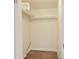 Organized closet with shelf, hanging rod, neutral wall paint, and vinyl flooring at 7214 W Reformatory Rd, Fortville, IN 46040
