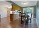 Dining area adjacent to the kitchen, featuring hardwood floors and views of the screened in porch at 7214 W Reformatory Rd, Fortville, IN 46040