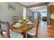 Dining area featuring hardwood floors, modern paint, and views of the connected rooms at 7214 W Reformatory Rd, Fortville, IN 46040