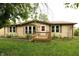 Charming single-story home featuring a front porch and well-maintained lawn and beige vinyl siding at 7214 W Reformatory Rd, Fortville, IN 46040