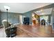 Inviting living room with hardwood floors, neutral tones, and an open layout to the kitchen and dining areas at 7214 W Reformatory Rd, Fortville, IN 46040