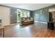 Cozy living room featuring a comfortable couch, natural light from the window, and updated flooring at 7214 W Reformatory Rd, Fortville, IN 46040