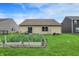 Well-maintained backyard with garden and view of the home's exterior at 7238 Moultrie Dr, Indianapolis, IN 46217