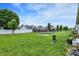 Green backyard area featuring a garden, lush lawn, and privacy fence at 7238 Moultrie Dr, Indianapolis, IN 46217