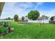 Spacious backyard features a well-kept lawn, raised garden beds, and privacy fencing at 7238 Moultrie Dr, Indianapolis, IN 46217