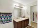 Bright bathroom featuring a vanity sink with a large mirror, and a towel rack for added convenience at 7238 Moultrie Dr, Indianapolis, IN 46217