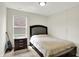 A cozy bedroom with a neutral color scheme is complimented by a large window with natural light at 7238 Moultrie Dr, Indianapolis, IN 46217