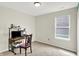 This is a bedroom with a computer desk and a chair. It features a window and a neutral color scheme at 7238 Moultrie Dr, Indianapolis, IN 46217