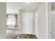 Bright entryway with neutral walls, tiled floor, and a view into the carpeted living area at 7238 Moultrie Dr, Indianapolis, IN 46217