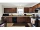 The kitchen is equipped with sleek dark cabinets and modern appliances, offering a functional cooking space at 7238 Moultrie Dr, Indianapolis, IN 46217