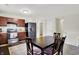Cozy kitchen features wood cabinets, stainless steel appliances, and an adjacent dining area for convenient meals at 7238 Moultrie Dr, Indianapolis, IN 46217