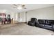 Open-concept living area with carpet flooring, ceiling fan, and a view into the kitchen at 7238 Moultrie Dr, Indianapolis, IN 46217