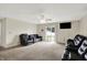 Spacious living room with plush carpeting, ceiling fan, and sliding door to the backyard at 7238 Moultrie Dr, Indianapolis, IN 46217