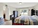 Spacious main bedroom featuring a large window and an ensuite bathroom, providing comfort and convenience at 7238 Moultrie Dr, Indianapolis, IN 46217