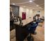 Finished basement with a bar area featuring a red refrigerator, a workout area, and stylish bar stools at 7255 Haverhill Ct, Indianapolis, IN 46250