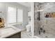 Updated bathroom featuring marble shower, vanity, and ample natural light from a large window at 7255 Haverhill Ct, Indianapolis, IN 46250