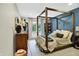 Bedroom with four-poster bed, natural light, and painted blue accent wall at 7255 Haverhill Ct, Indianapolis, IN 46250