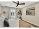 Bright bedroom with large window, hardwood floors, and ceiling fan at 7255 Haverhill Ct, Indianapolis, IN 46250